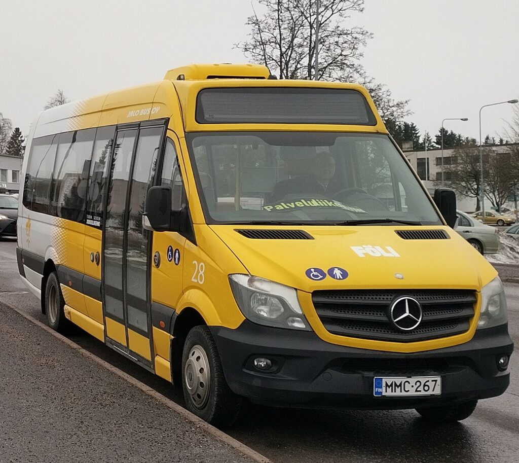 Kelta-valkoinen palveluliikenteen pikkubussi.