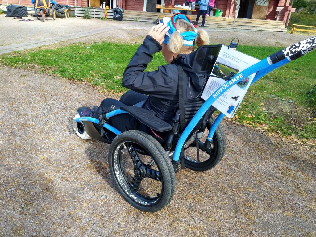 Henkilö istumassa maastopyörätuoli Hippocampen kyydissä.