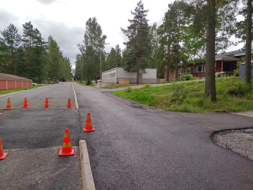 Juuri asvaltoitu kevyenliikenteenväylä ja Kriivarin koulun rakennuksia