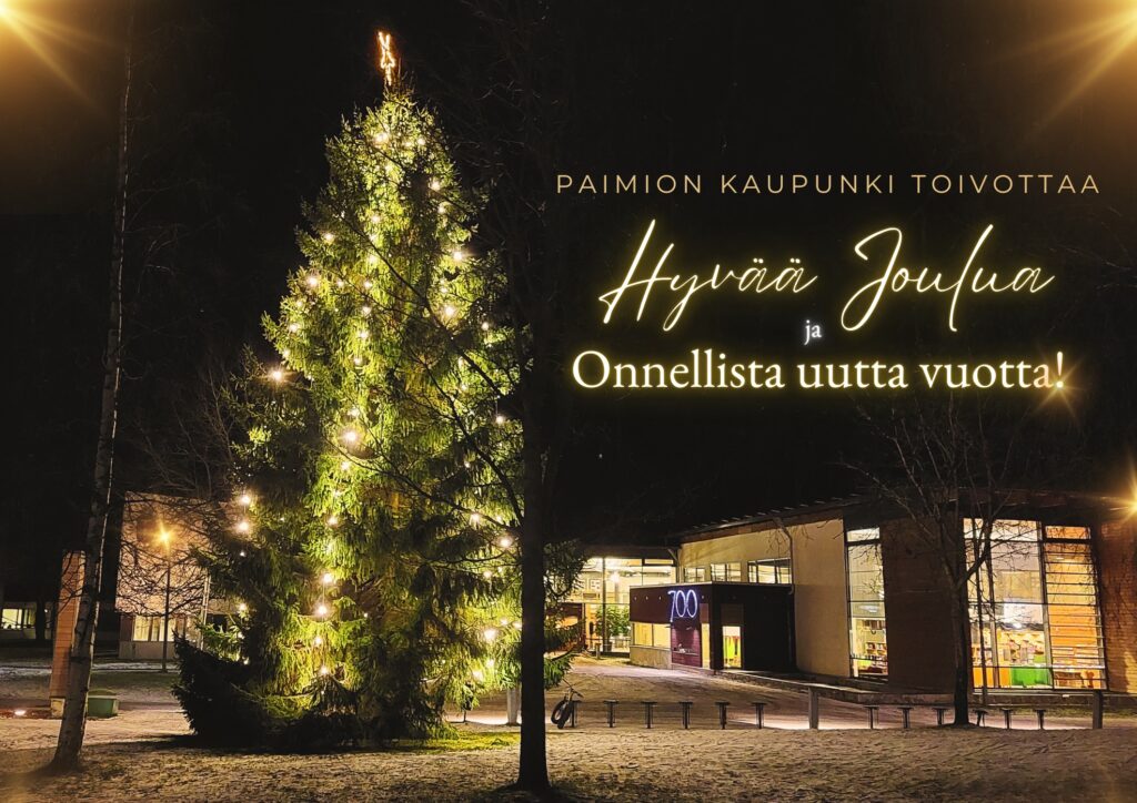 Valaistu joulukuusia ja kaupungintalo sekä teksti Paimion kaupunki toivottaa Hyvää Joulua ja Onnellista Uutta Vuotta.